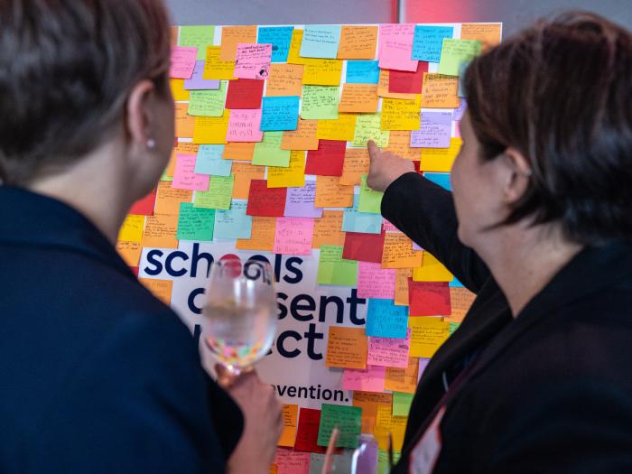 pointing at post it on the board